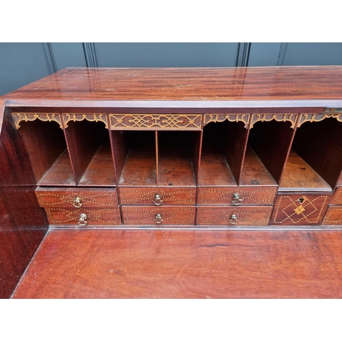 1083 - A George III mahogany bureau, the interior with inlaid drawers, 112cm wide. 