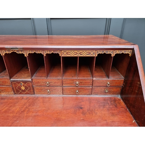 1083 - A George III mahogany bureau, the interior with inlaid drawers, 112cm wide. 