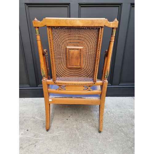 1087 - A pair of late Victorian satinwood and painted bergere chairs, (cane lacking to arms of one).... 