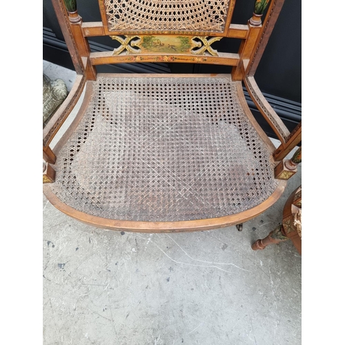 1087 - A pair of late Victorian satinwood and painted bergere chairs, (cane lacking to arms of one).... 