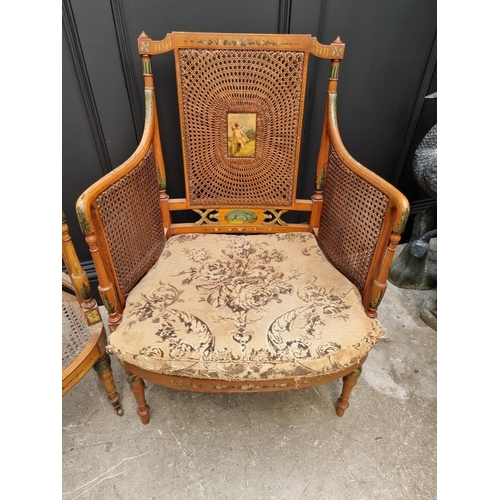 1087 - A pair of late Victorian satinwood and painted bergere chairs, (cane lacking to arms of one).... 