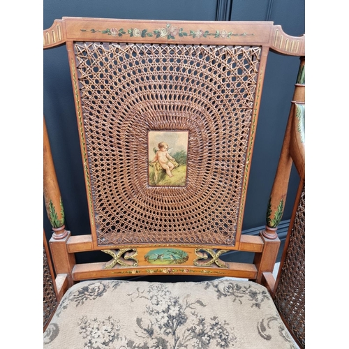 1087 - A pair of late Victorian satinwood and painted bergere chairs, (cane lacking to arms of one).... 