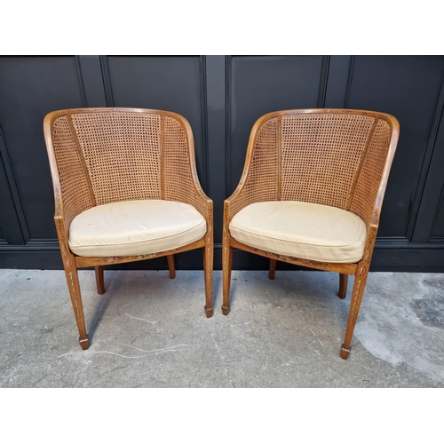 1089 - A pair of late Victorian satinwood, painted and cane tub chairs.  