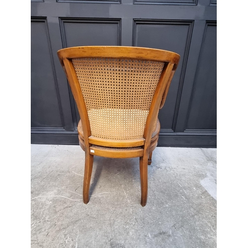 1089 - A pair of late Victorian satinwood, painted and cane tub chairs.  