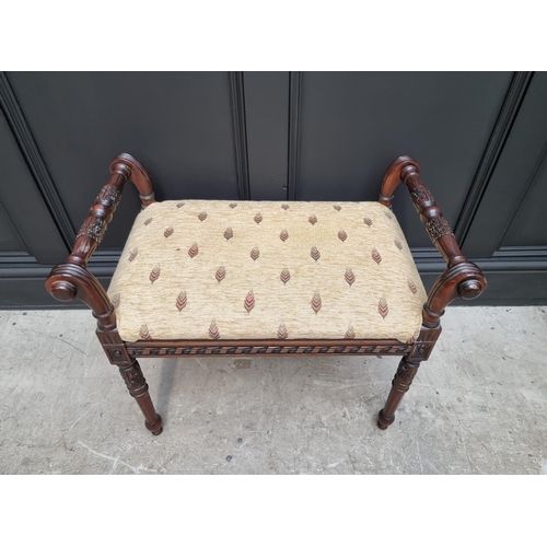 1094 - A reproduction carved hardwood window seat, 68cm wide. 