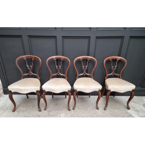 1096 - A set of four Victorian rosewood balloon back dining chairs.