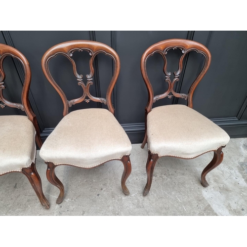 1096 - A set of four Victorian rosewood balloon back dining chairs.