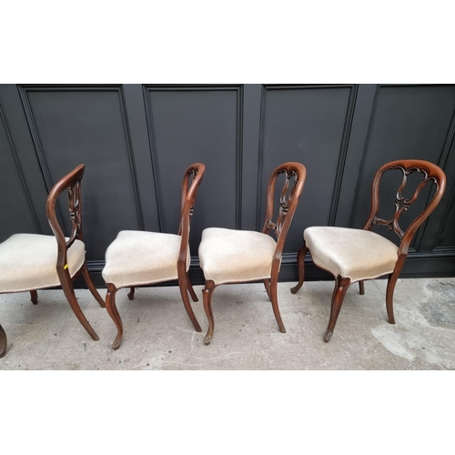 1096 - A set of four Victorian rosewood balloon back dining chairs.