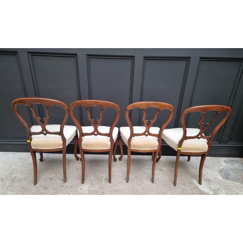 1096 - A set of four Victorian rosewood balloon back dining chairs.