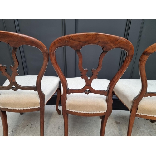 1096 - A set of four Victorian rosewood balloon back dining chairs.