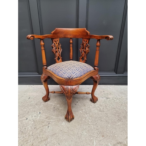 1097 - A modern carved hardwood corner chair. 