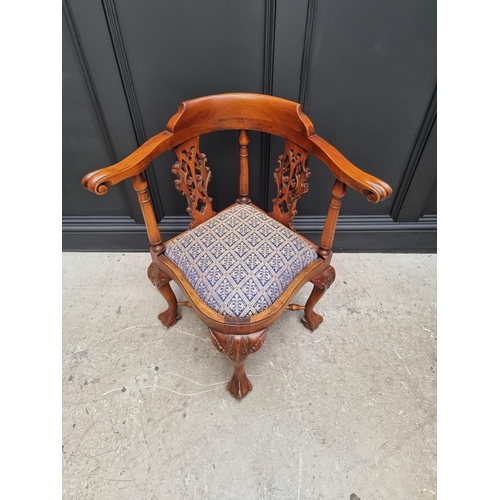 1097 - A modern carved hardwood corner chair. 