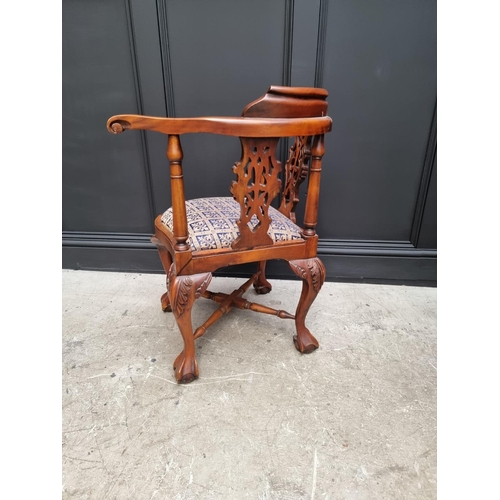 1097 - A modern carved hardwood corner chair. 