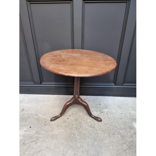 1101 - A George III mahogany circular tilt top tripod table, with bird-cage action, 71cm wide.... 