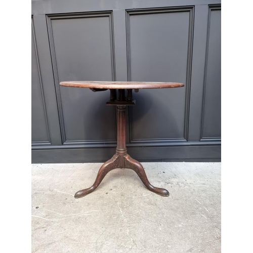 1101 - A George III mahogany circular tilt top tripod table, with bird-cage action, 71cm wide.... 