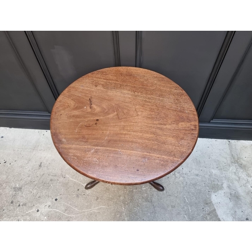 1101 - A George III mahogany circular tilt top tripod table, with bird-cage action, 71cm wide.... 