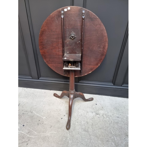 1101 - A George III mahogany circular tilt top tripod table, with bird-cage action, 71cm wide.... 