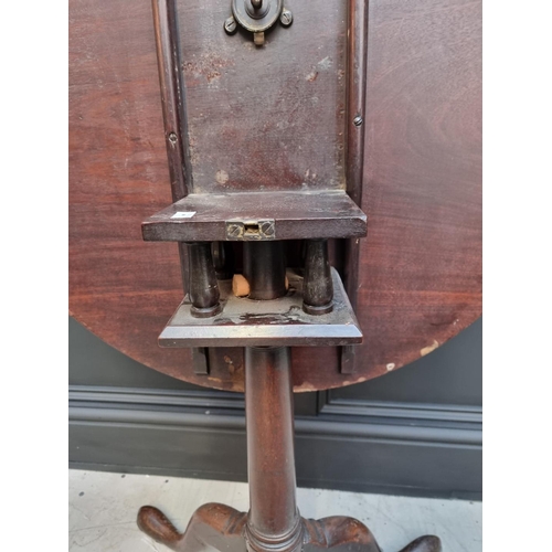 1101 - A George III mahogany circular tilt top tripod table, with bird-cage action, 71cm wide.... 