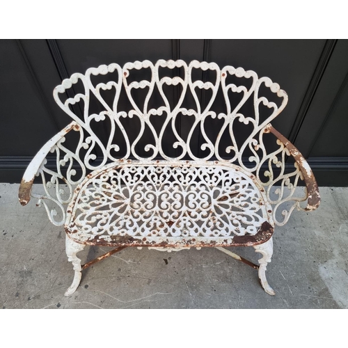 1106 - An old white painted wrought and cast iron bench, 93cm wide. 