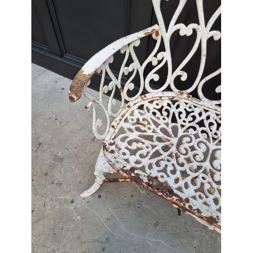 1106 - An old white painted wrought and cast iron bench, 93cm wide. 