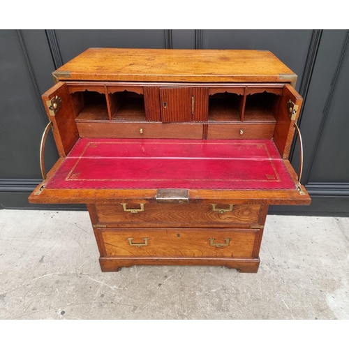 1112 - An unusually small 19th century teak and brass bound campaign chest, with secretaire drawer and side... 