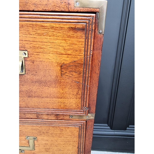 1112 - An unusually small 19th century teak and brass bound campaign chest, with secretaire drawer and side... 