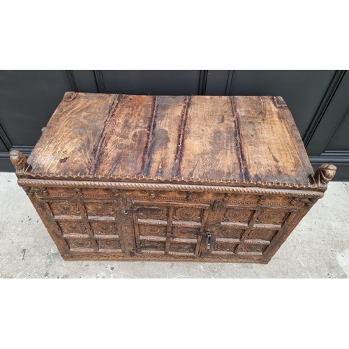 1115 - An Indian carved hardwood chest, with small central cupboard door, 97.5cm wide. ... 