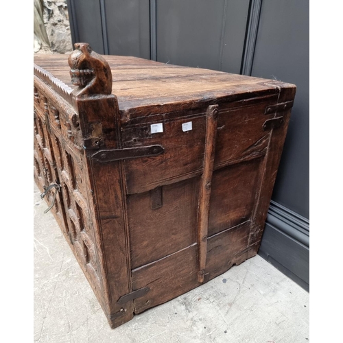 1115 - An Indian carved hardwood chest, with small central cupboard door, 97.5cm wide. ... 