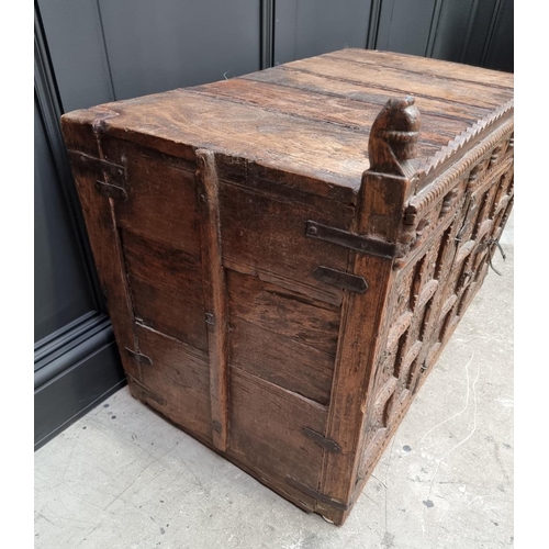 1115 - An Indian carved hardwood chest, with small central cupboard door, 97.5cm wide. ... 