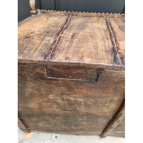 1115 - An Indian carved hardwood chest, with small central cupboard door, 97.5cm wide. ... 