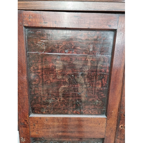 1116 - An 18th century oak press cupboard, incorporating 17th century Italian Cypress wood panels, 164cm wi... 