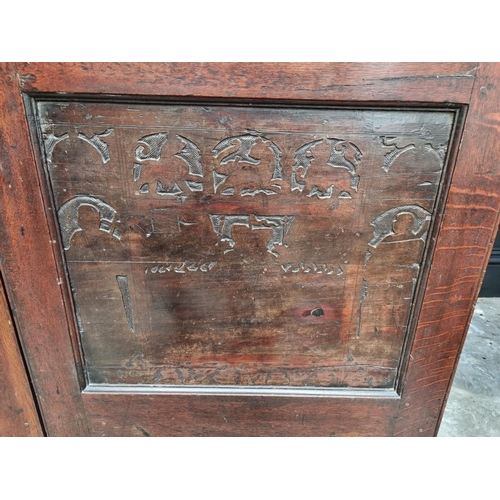 1116 - An 18th century oak press cupboard, incorporating 17th century Italian Cypress wood panels, 164cm wi... 