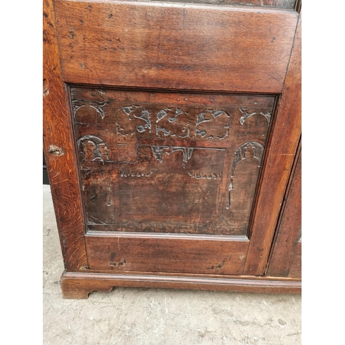 1116 - An 18th century oak press cupboard, incorporating 17th century Italian Cypress wood panels, 164cm wi... 