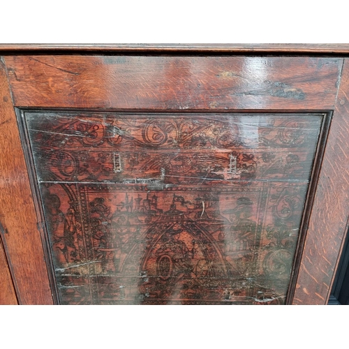 1116 - An 18th century oak press cupboard, incorporating 17th century Italian Cypress wood panels, 164cm wi... 