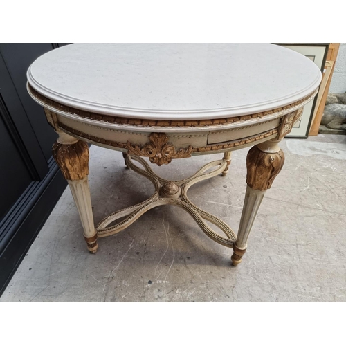 1117 - An old Louis XVI style cream painted and parcel gilt circular centre table, with travertine top and ... 