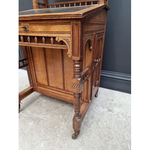 1121 - An unusual late Victorian oak Davenport, 61cm wide.