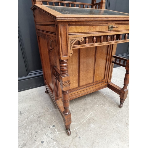 1121 - An unusual late Victorian oak Davenport, 61cm wide.