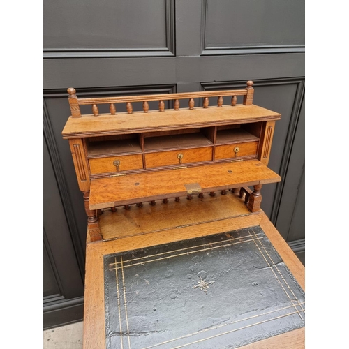 1121 - An unusual late Victorian oak Davenport, 61cm wide.