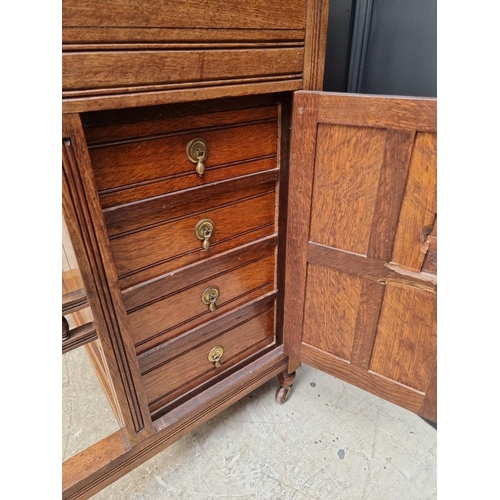 1121 - An unusual late Victorian oak Davenport, 61cm wide.