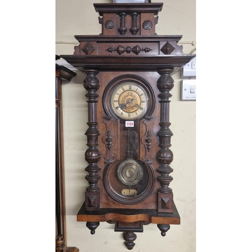 1124 - An antique walnut Vienna style wall clock, spring driven, 92cm high, with pendulum.