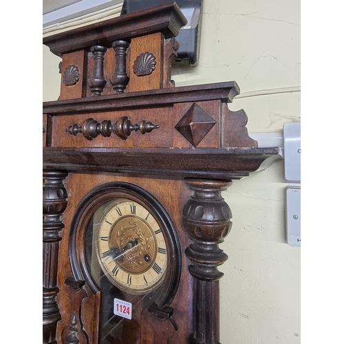 1124 - An antique walnut Vienna style wall clock, spring driven, 92cm high, with pendulum.