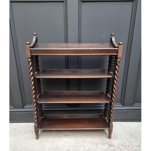 1130 - A late Victorian carved oak bookcase, 91cm wide; together with a 1920s oak and cane open bookcase, 6... 