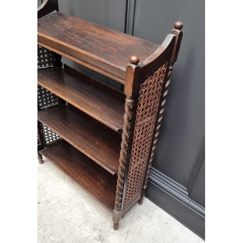 1130 - A late Victorian carved oak bookcase, 91cm wide; together with a 1920s oak and cane open bookcase, 6... 