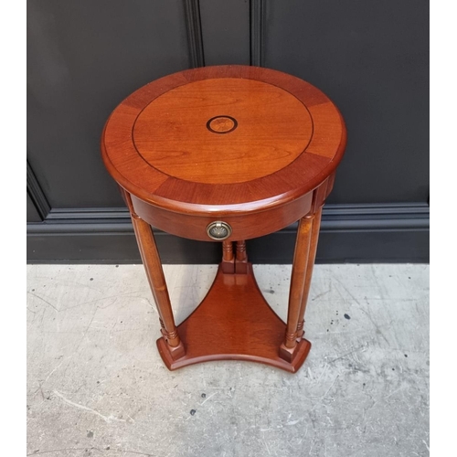 1134 - A reproduction mahogany and inlaid circular occasional table, with frieze drawer, 40cm diameter.&nbs... 