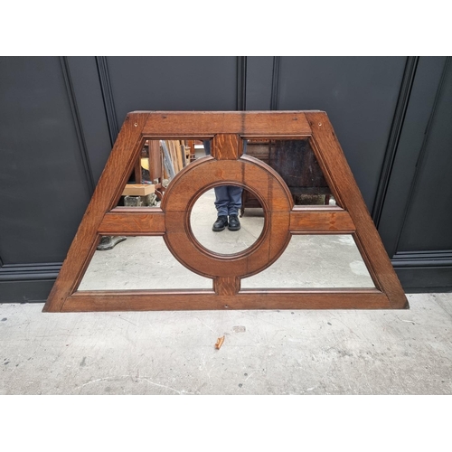 1137 - An antique oak and mirrored glass panel, of rhomboid form, 84.5 x 164cm. 