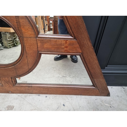 1137 - An antique oak and mirrored glass panel, of rhomboid form, 84.5 x 164cm. 