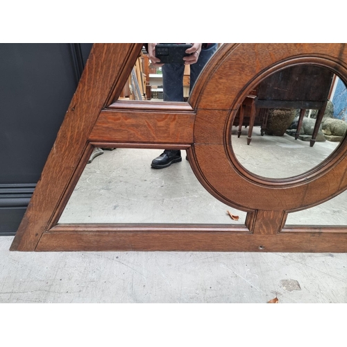 1137 - An antique oak and mirrored glass panel, of rhomboid form, 84.5 x 164cm. 