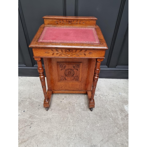 1140 - A circa 1900 oak Davenport, 54.5cm wide.