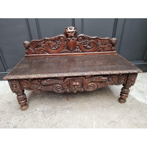 1141 - A late Victorian carved oak low hall table, with a lateral frieze drawer, 127cm wide, (reduced in he... 