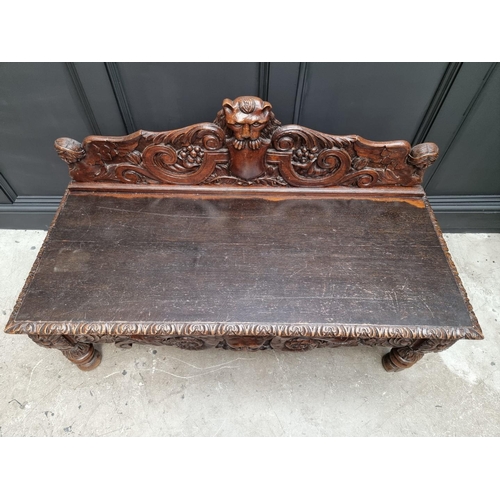 1141 - A late Victorian carved oak low hall table, with a lateral frieze drawer, 127cm wide, (reduced in he... 